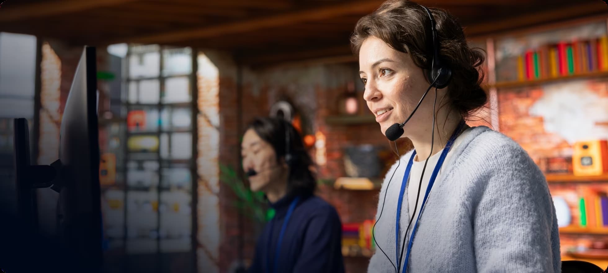telecom agent with a headphone having a meeting over a laptop