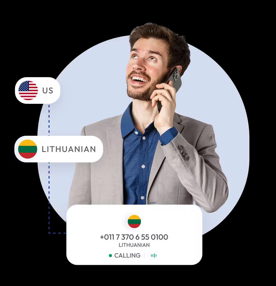 smiling man in a suit jacket and blue shirt talking on a smartphone