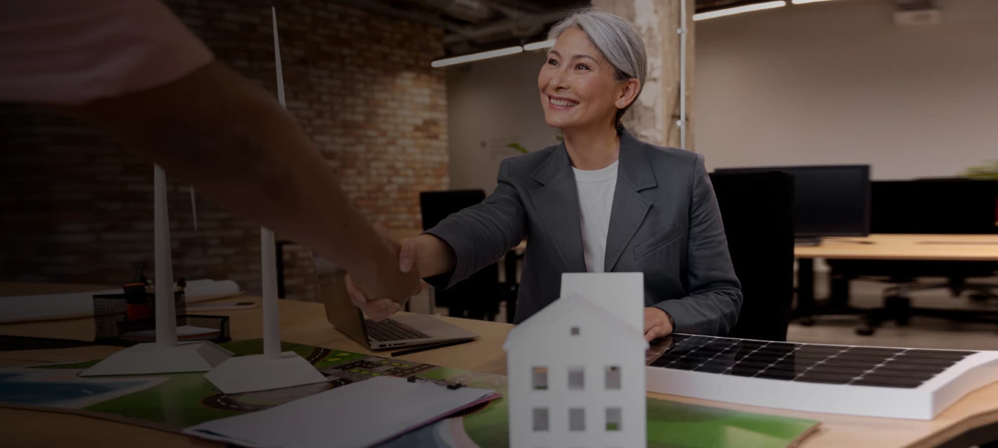 two professionals collaborating on a business project using a laptop