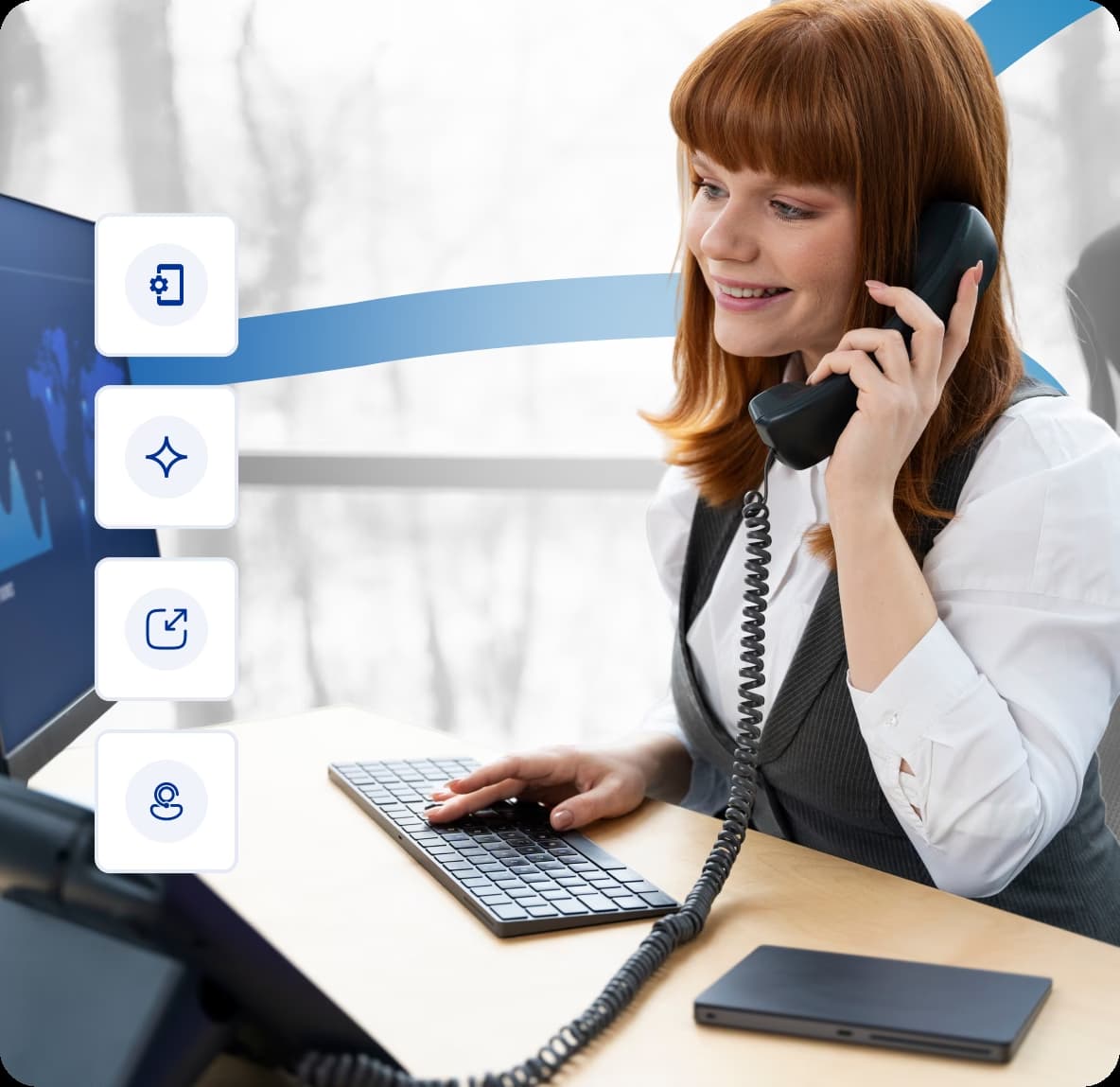 Professional receptionist using a business phone system and desktop computer with communication software icons